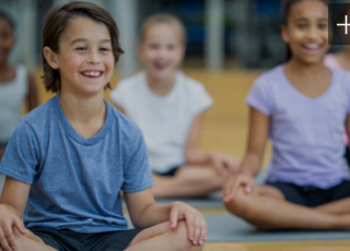 children smiling doing yoga